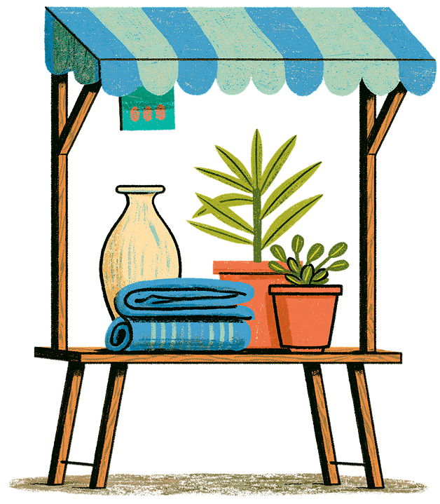 Un étal de créateur présentant des poteries, du linge et des plantes